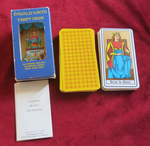 Oswald Wirth Tarot Deck with blue window box, yellow patterned card backs, Queen of Batons, and folded printed insert