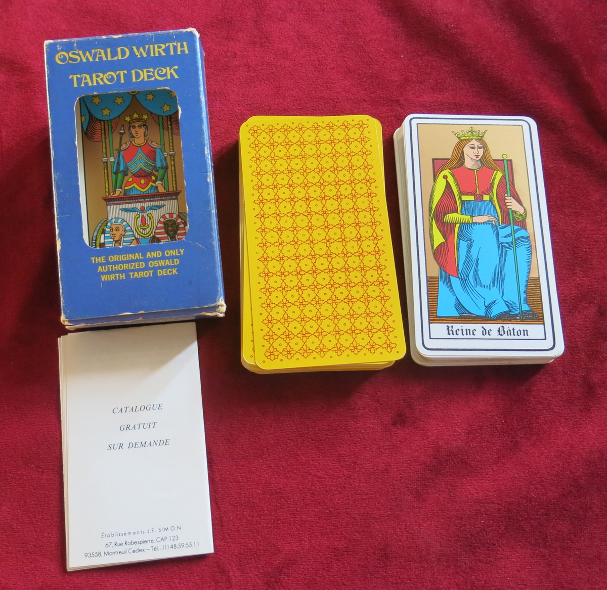Oswald Wirth Tarot Deck with blue window box, yellow patterned card backs, Queen of Batons, and folded printed insert