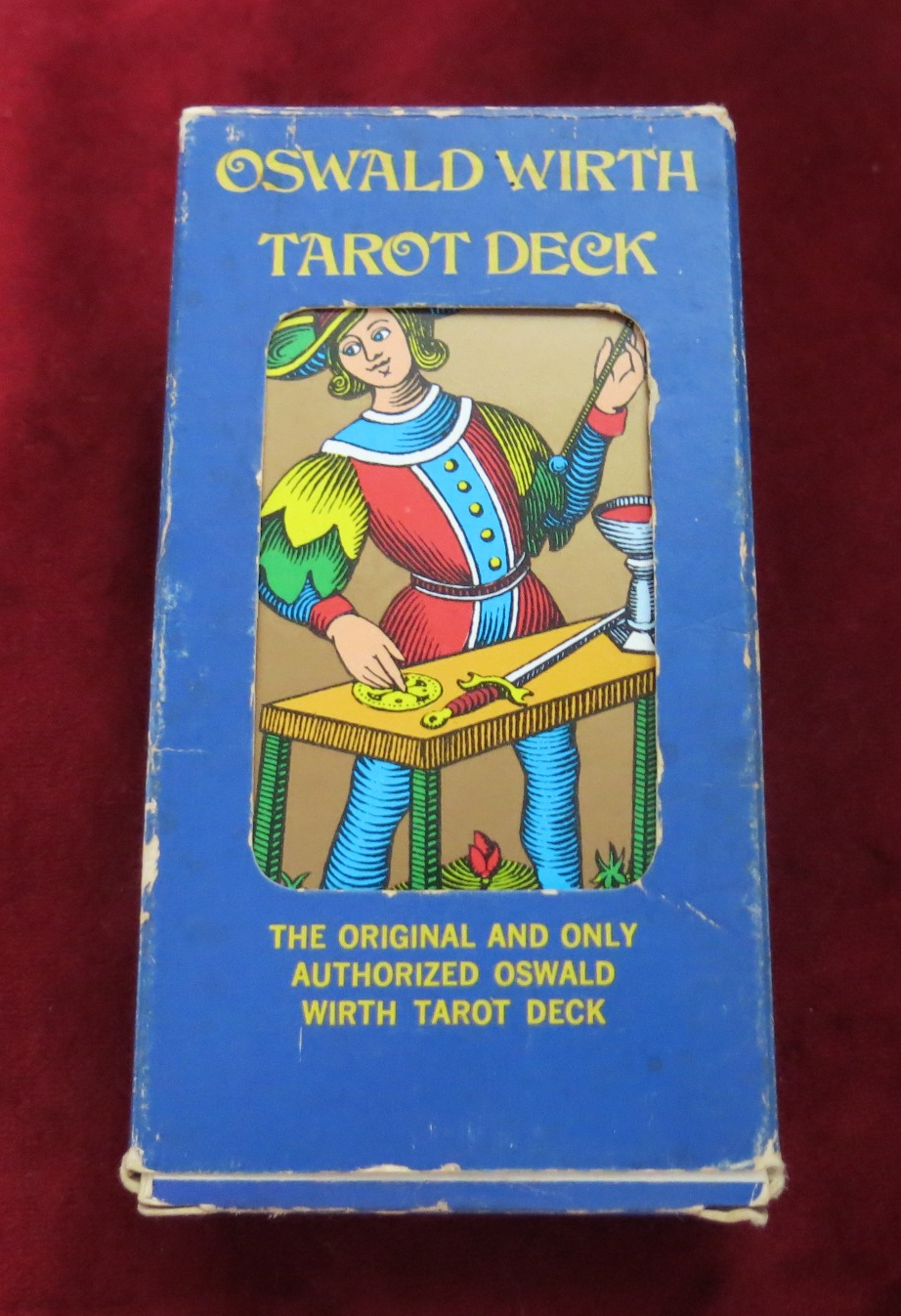 Front of the blue Oswald Wirth Tarot Deck window box, showing edge and corner wear